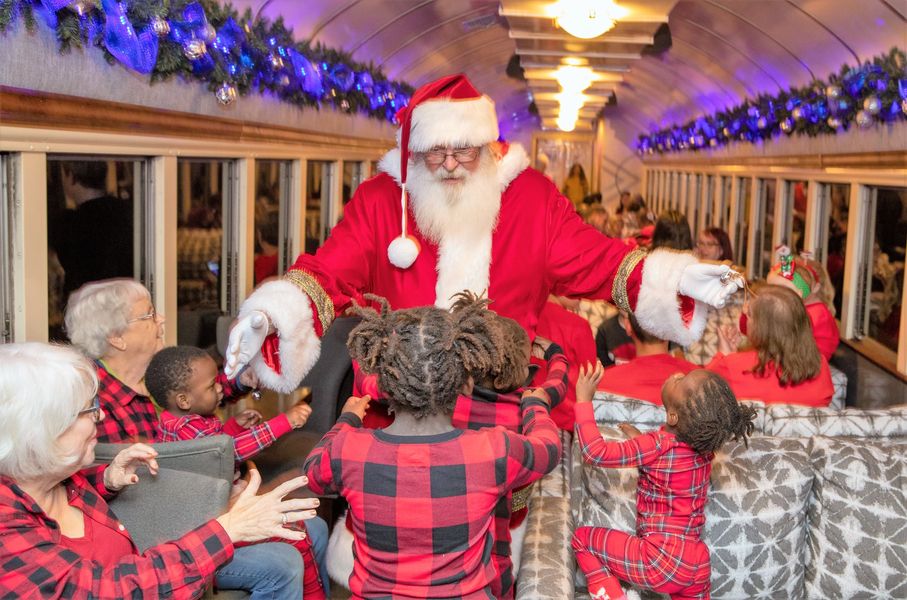 Santa greets a group of children on board the Polar Express